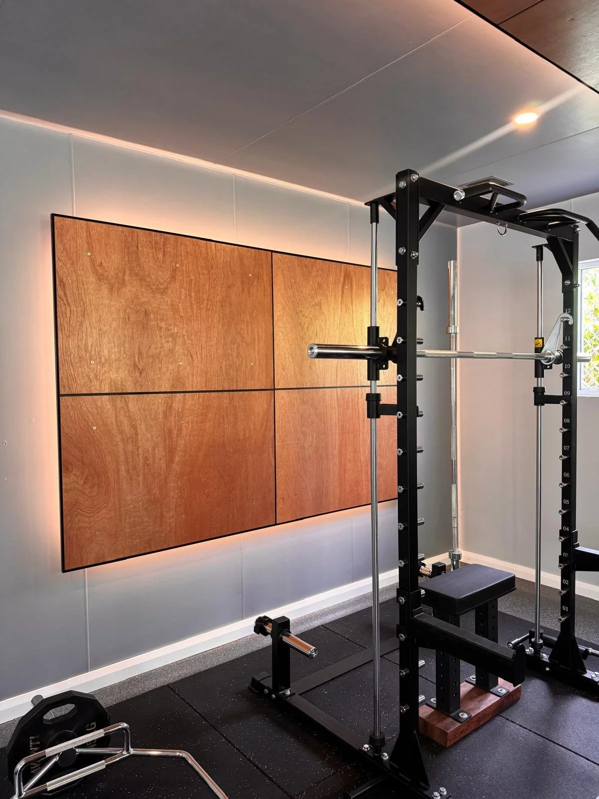 LED backlit timber wall panel installation in modern home gym by Sharp Electrical & Air.
