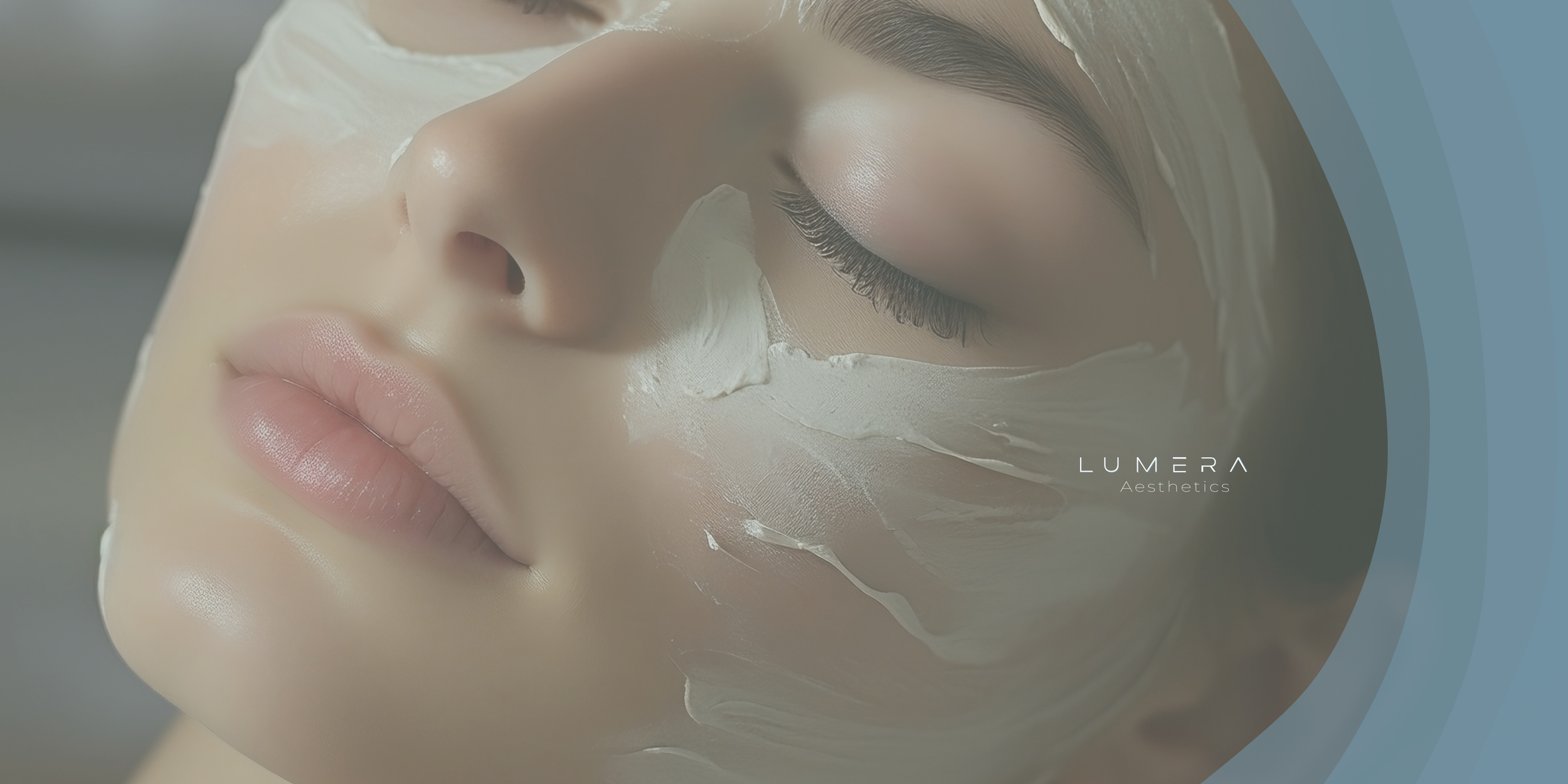 Close-up of a woman with her eyes closed, receiving a facial treatment with a cream mask applied to her face, labeled 'LUMERA Aesthetics.'