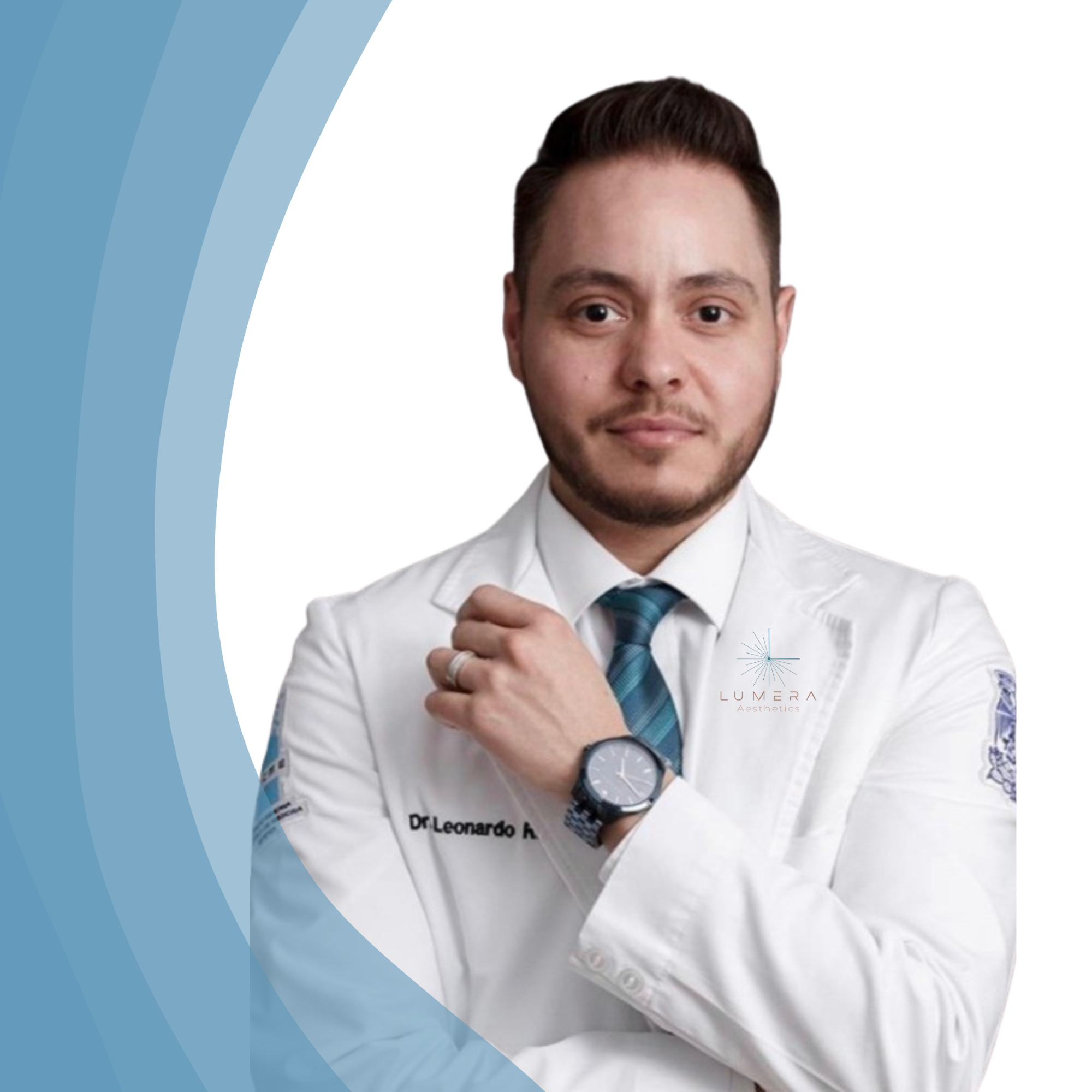 A male doctor in a white coat with the logo LUMERA Aesthetics, wearing a watch and a striped tie, looking at the camera with a confident expression.