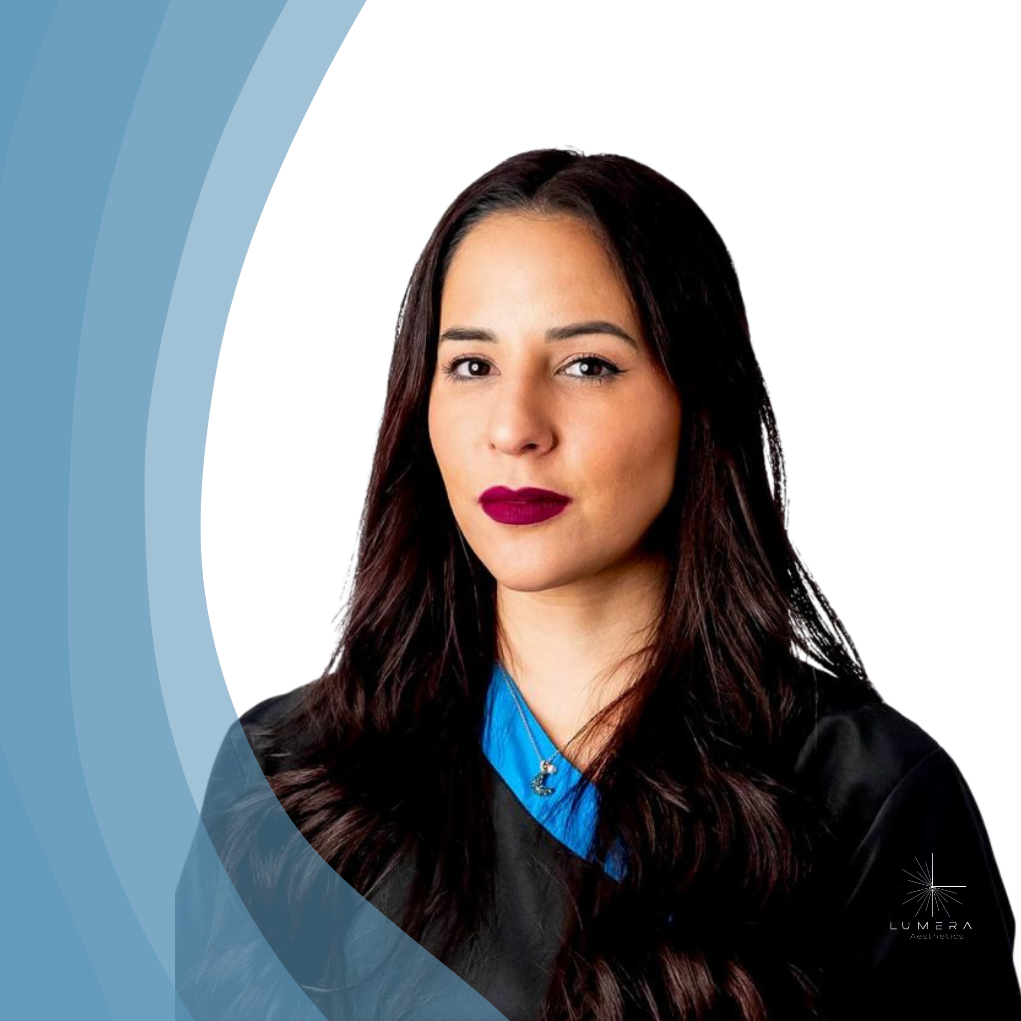 A woman with long dark hair, wearing a black academic gown with a blue collar, and dark lipstick, posing for a portrait against a white background with light blue graphic elements in the corner.