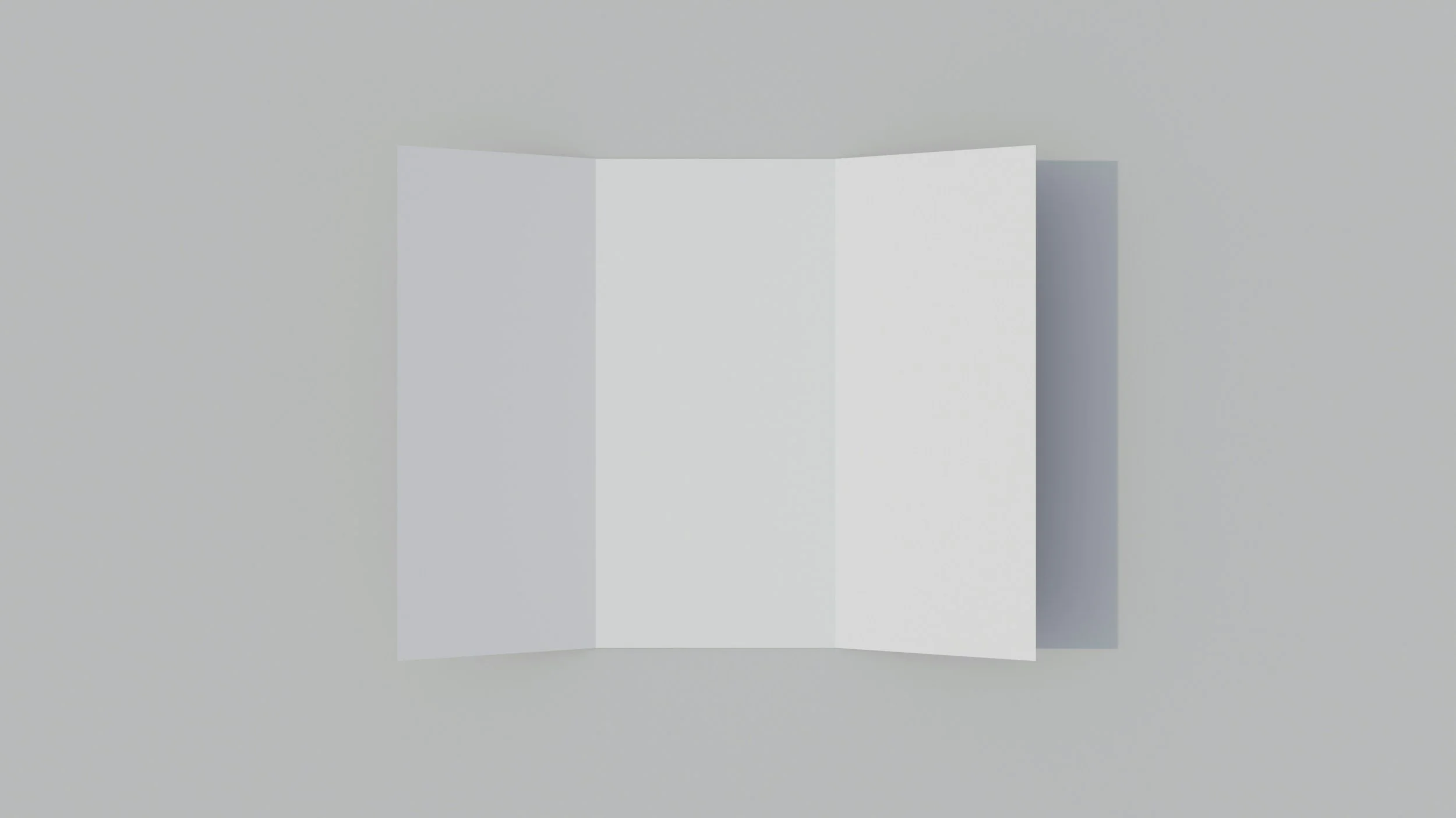 A blank white tri-fold brochure or pamphlet standing open on a light gray surface against a light gray background.