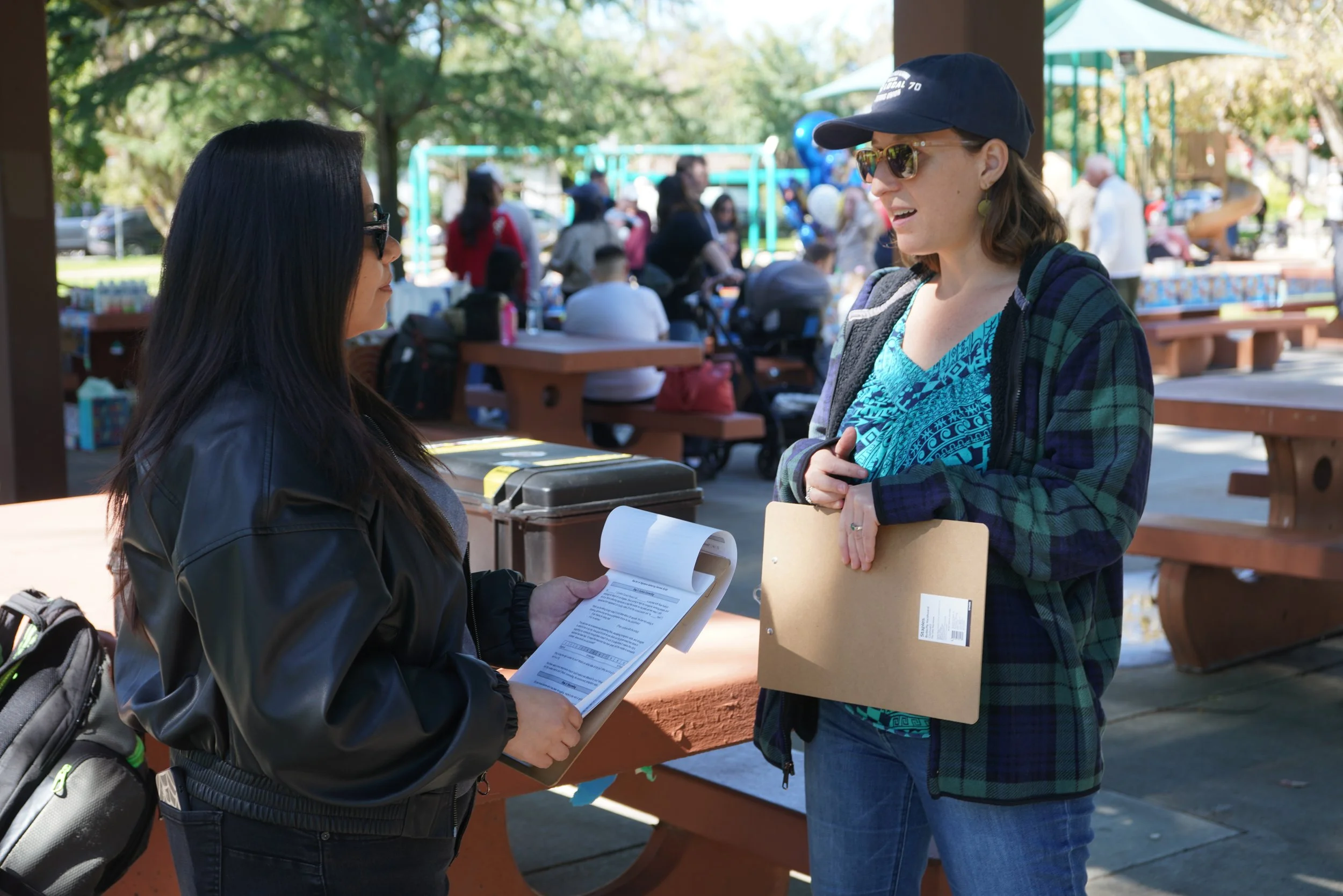 2 volunteers talking to one another