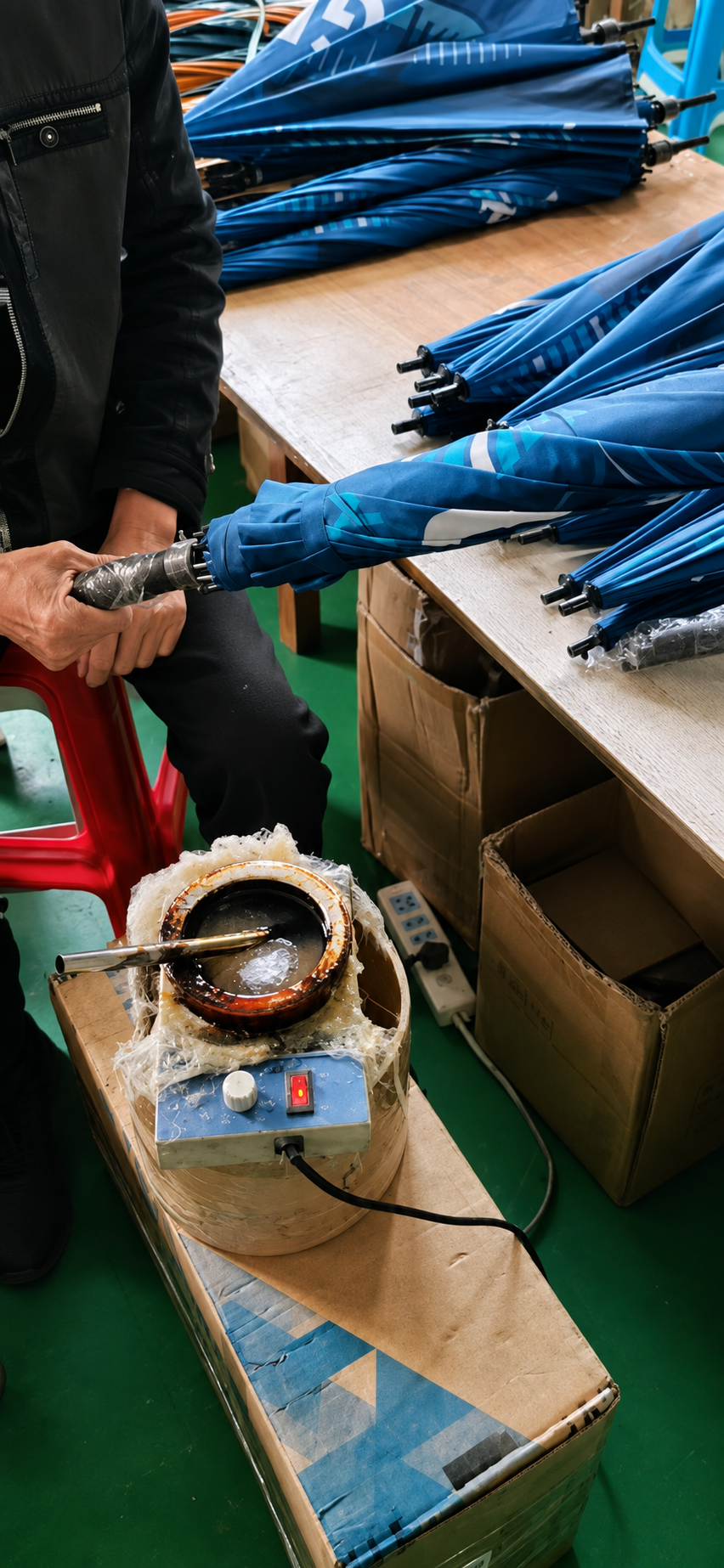 Custom umbrella handle assembly during branded merchandise production