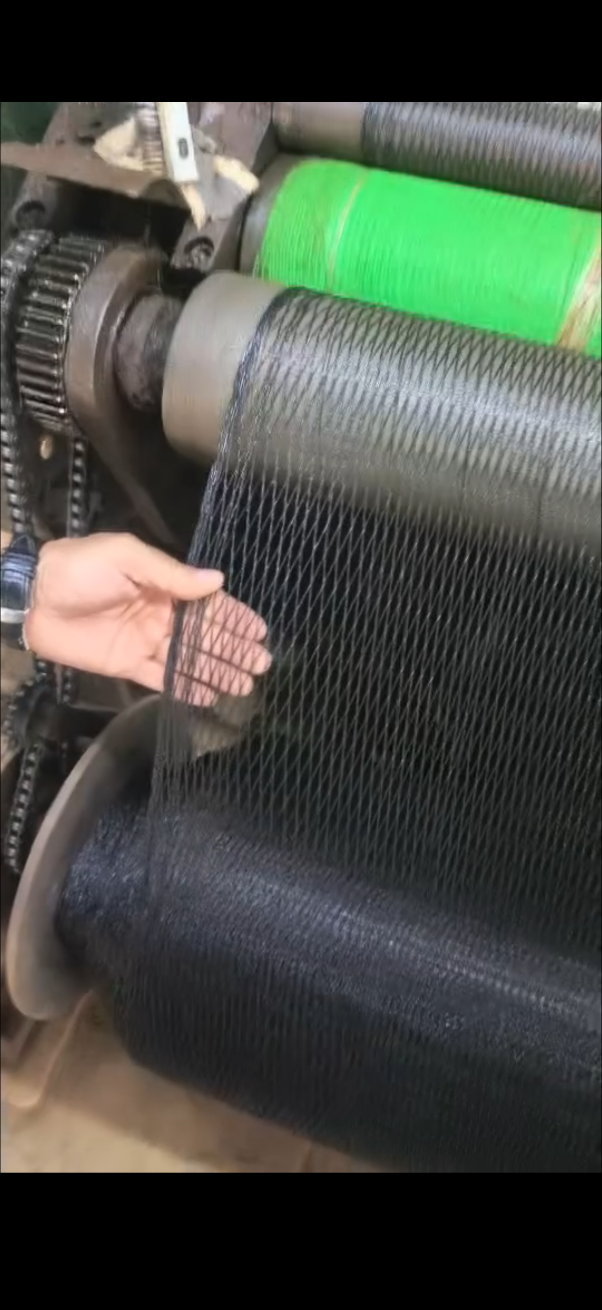 Close-up review of black vineyard bird netting mesh structure during production