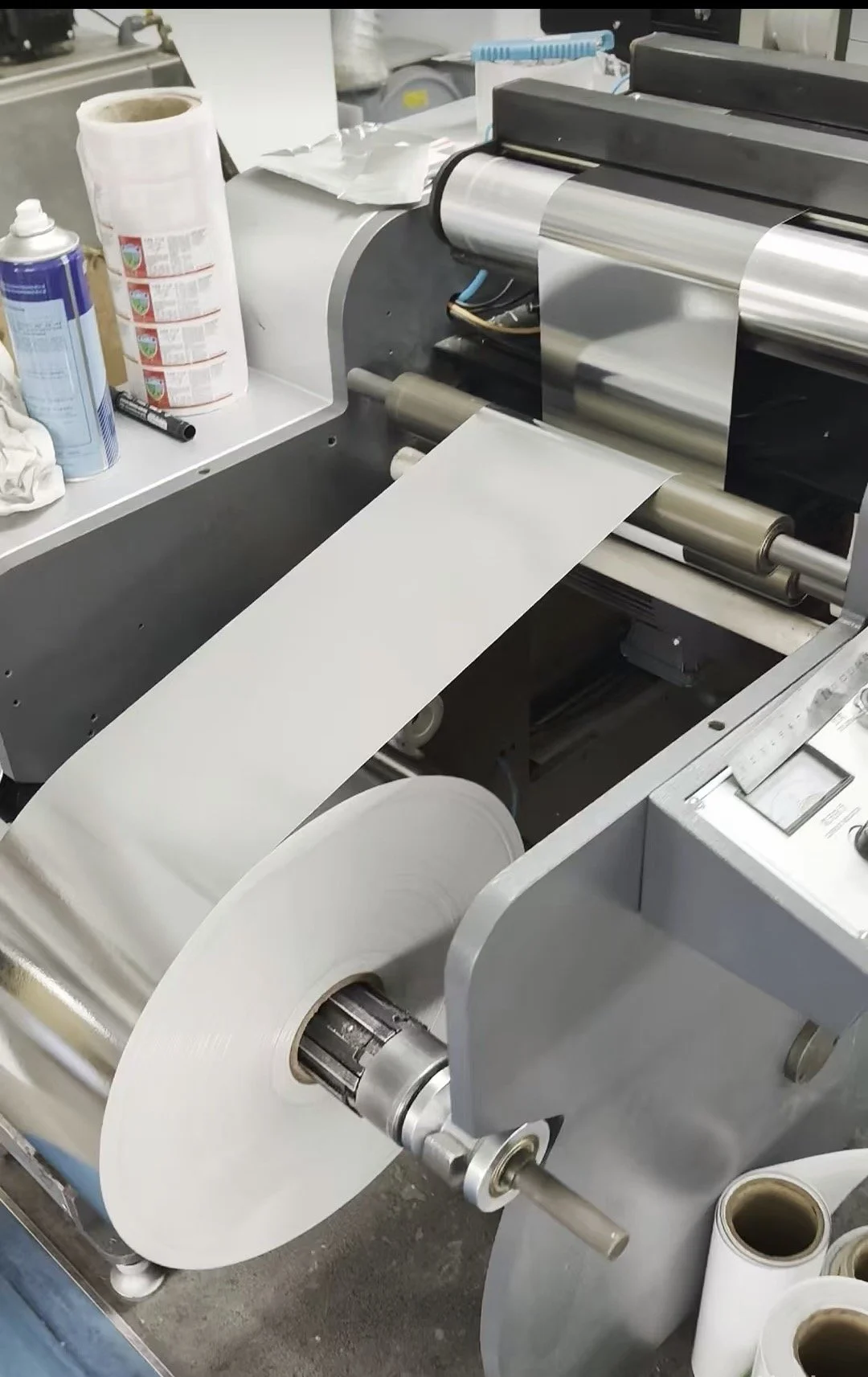 Custom wine label material running through production equipment