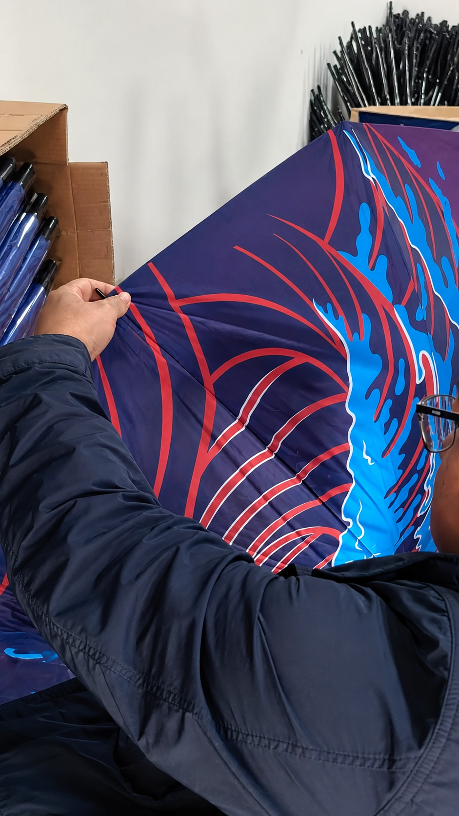 Custom branded umbrella canopy print inspection during brewery merchandise production
