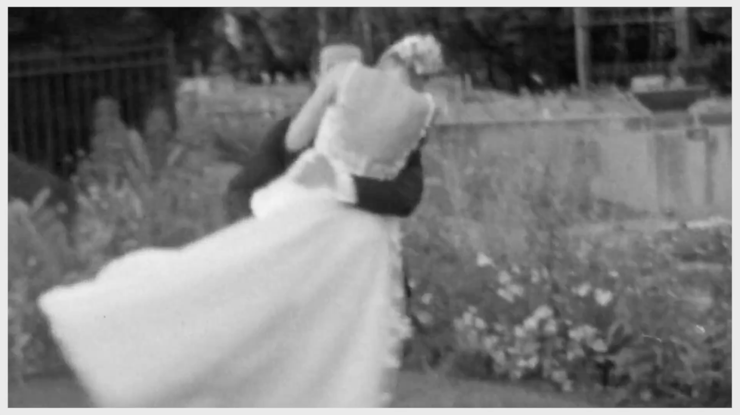A wedding couple in a state of euphoria as her groom sweeps her off of her feet.