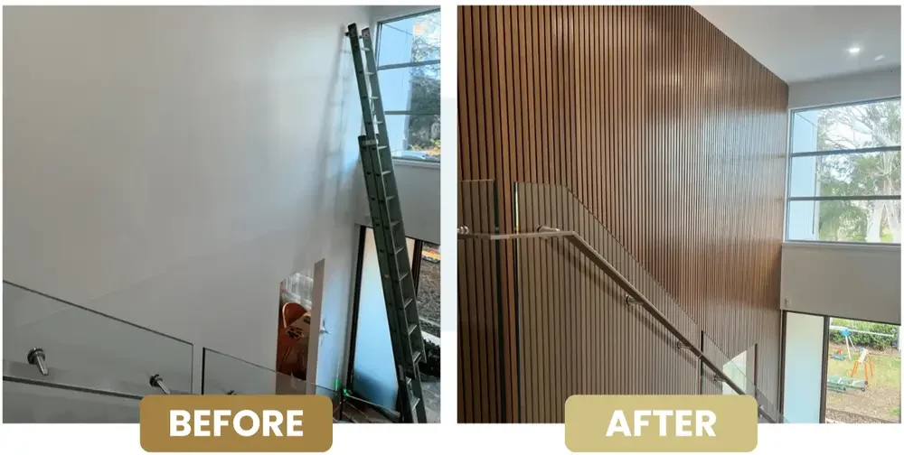 Photo showing a staircase area before and after renovation. In the 'before' image, the wall is plain white, with a ladder leaning against it and a window nearby. In the 'after' image, the wall has been covered with wooden paneling, giving a warm and modern look, with the staircase railing still visible.