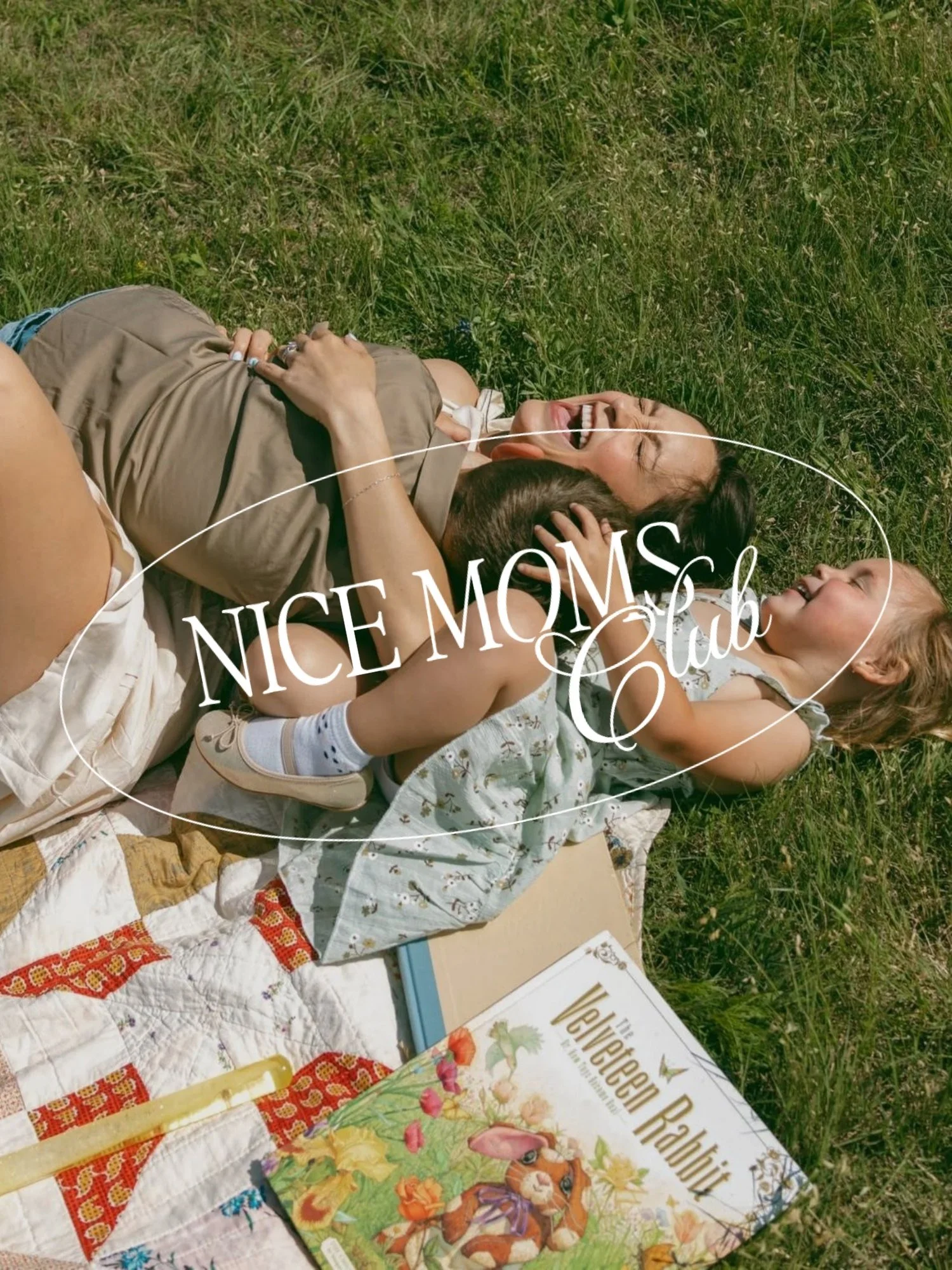 A woman and a young child lying on the grass, playing and laughing together with Nice Moms Club branding overlaid on top