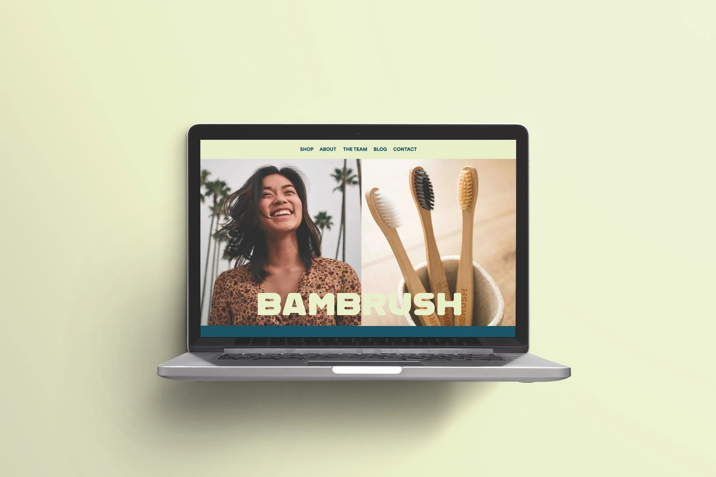 Laptop displaying a website with a photo of a smiling woman and toothbrushes in a cup, with the text 'BAMBRUSH' on the screen.