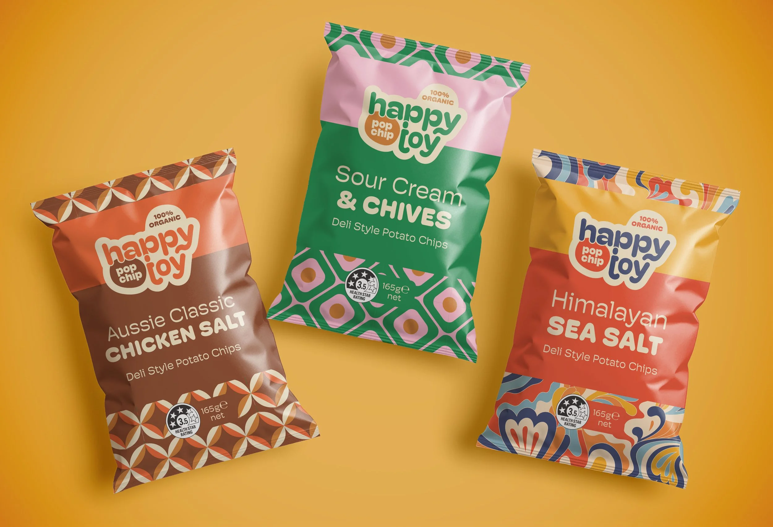 Three colourful bags of potato chips on a yellow background. The bags are labeled Aussie Classic Chicken Salt, Sour Cream & Chives, and Himalayan Sea Salt.