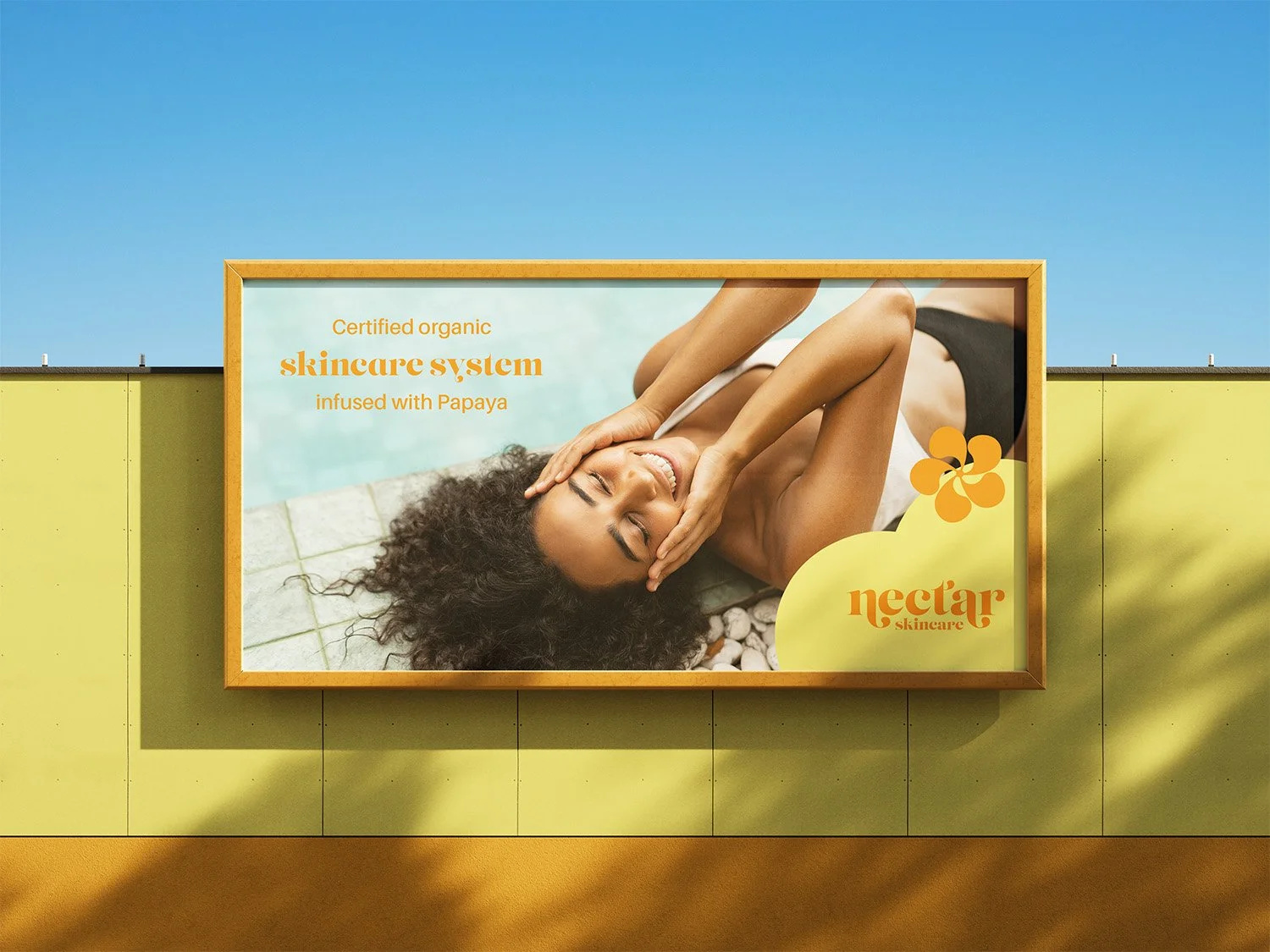 Billboard advertisement for Nectar skincare featuring a woman with curly hair relaxing beside a pool, with text describing organic skincare infused with papaya.