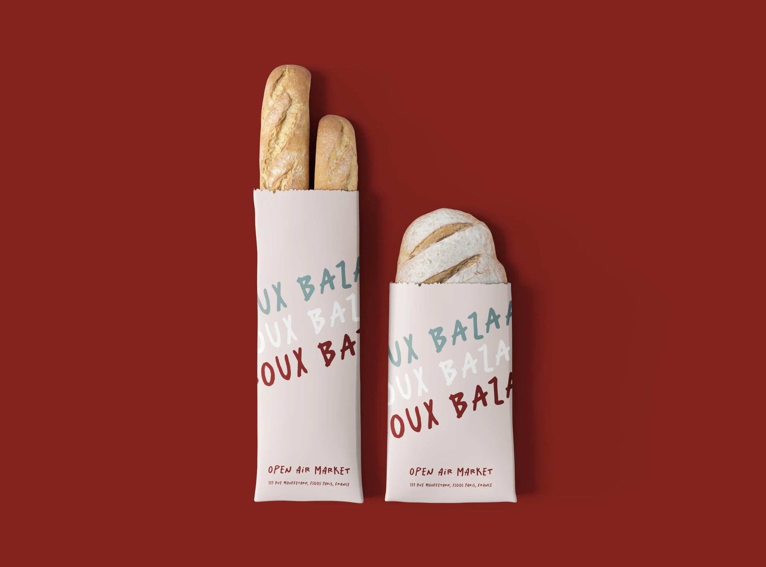Two loaves of bread in white paper bags with colorful text, set against a red background.