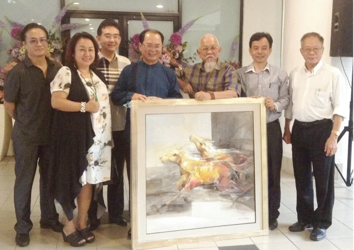 A group of eight people standing behind a painting of a horse, with some pink and purple flowers in the background.