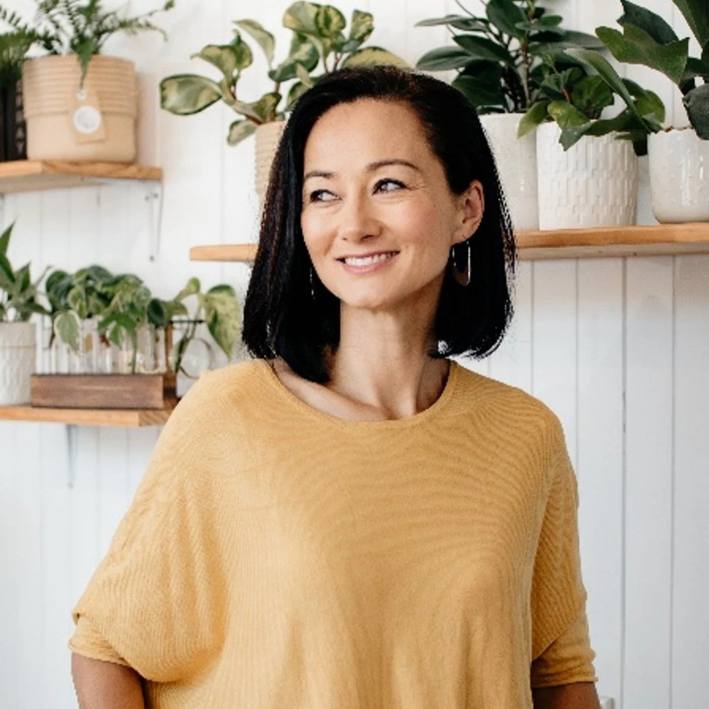 white-jade-holistic-health-founder-melissa-bergin-smiling-looking-at-distance-calmly-mind-body-medicine-sydney-new-south-wales