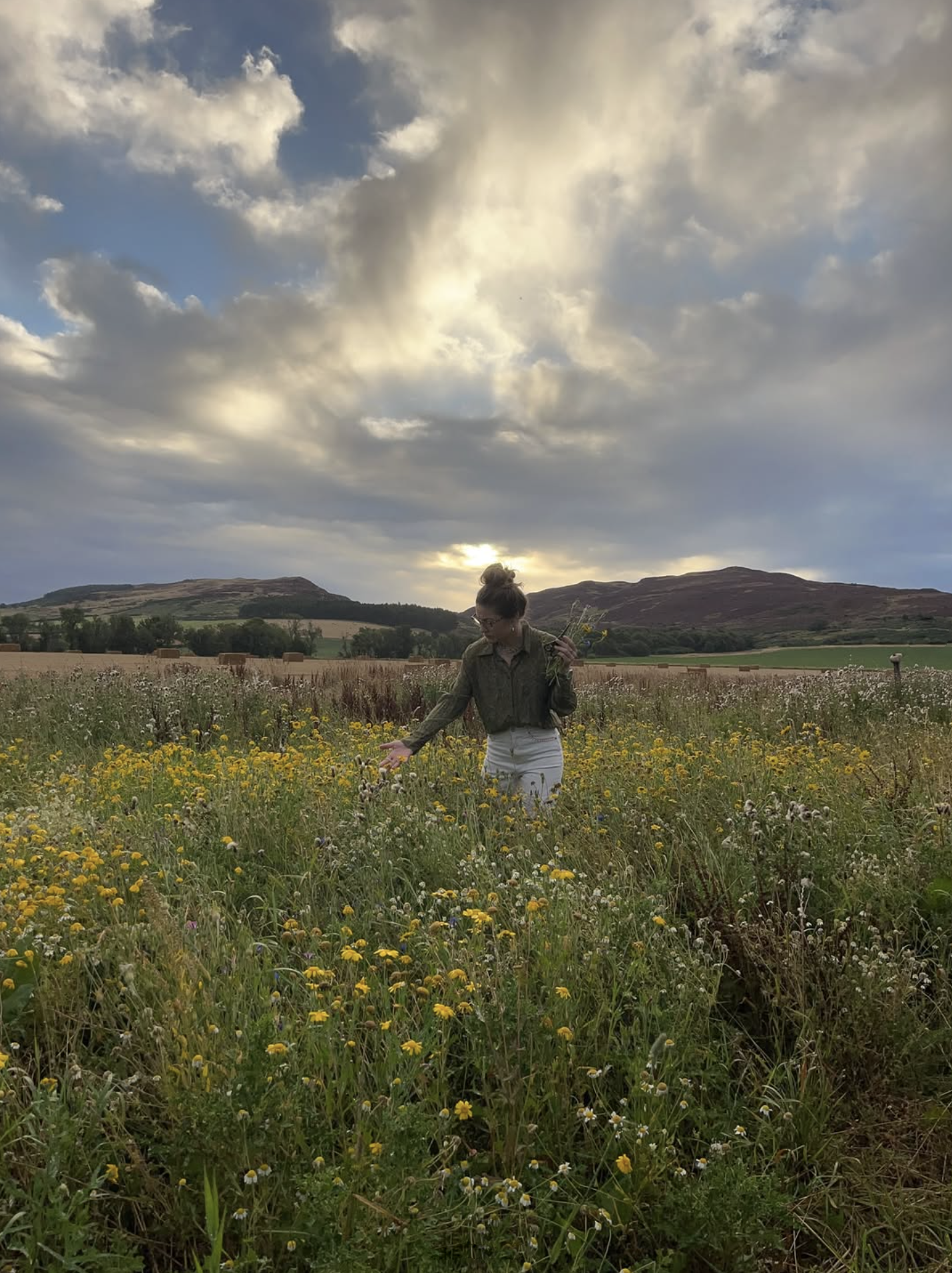 Katy Eccles of Imprint Casts gathering wild flowers and foliage on one of her collaborative Grand Tour exchanges