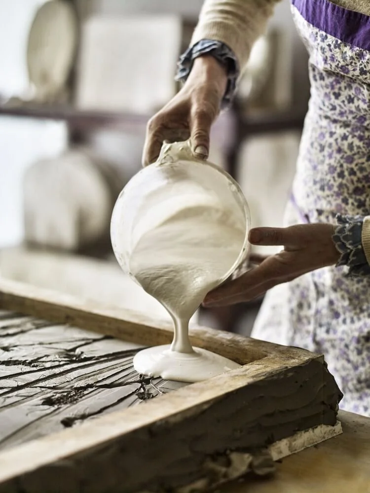 Katy Eccles of Imprint Casts pouring liquid plaster into a botanical cast mould