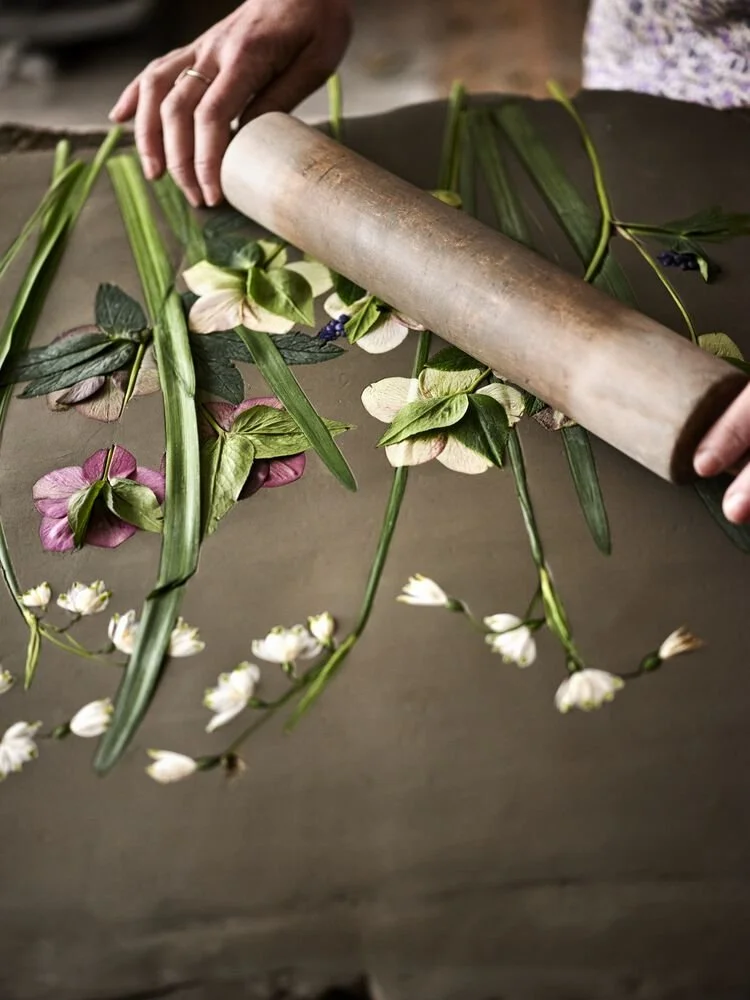 Katy Eccles of Imprint Casts rolling fresh botanicals into clay to make a plaster cast