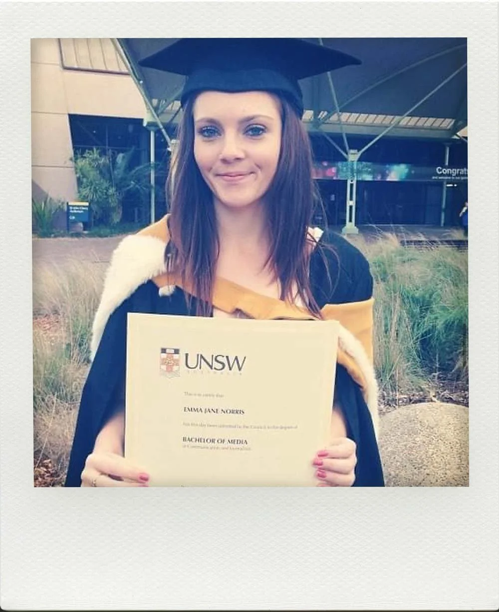 Emma Clark-Norris in graduating from UNSW with a Bachelors In Media and Journalism in 2013, standing outdoors near a modern building and landscaping.