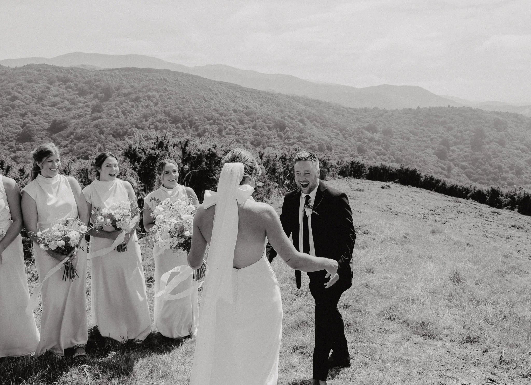 groom seeing his brideand has a massive smile on his face