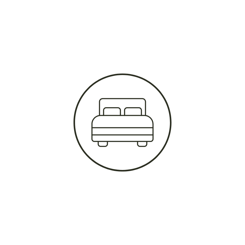 Line drawing of a bed inside a circle with nightstand and lamps in a bedroom setting.