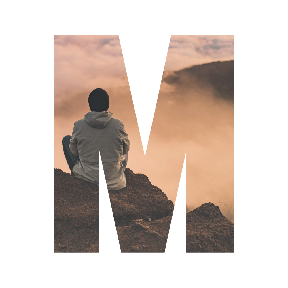 Person sitting on rocky mountain edge overlooking clouds and distant mountains at sunrise or sunset.