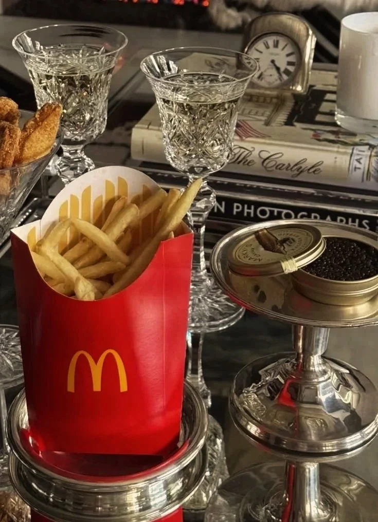 Juxtaposition of McDonald’s fries, caviar, and crystal glassware — playful take on high-low branding and modern luxury.