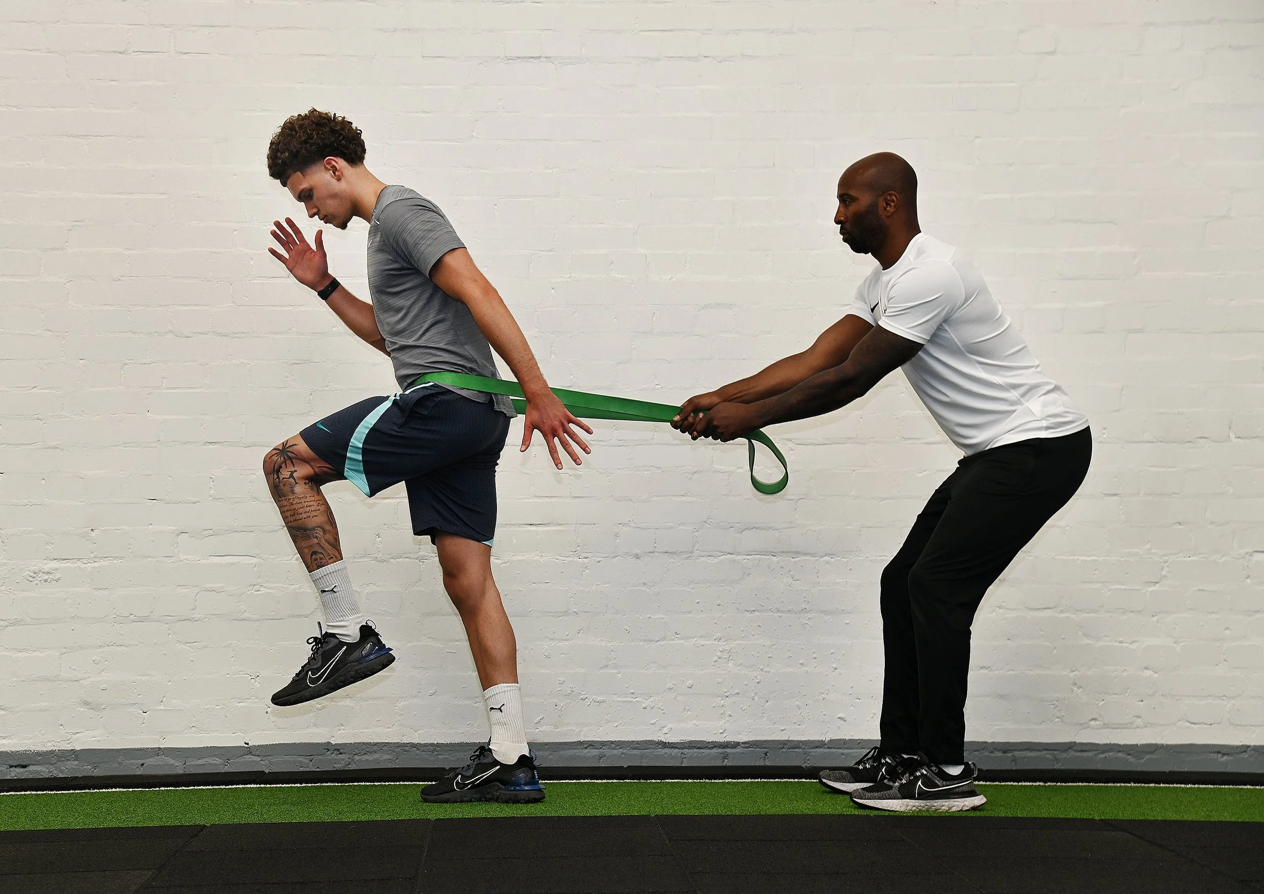 Footballer working through return-to-play rehab with a sports physiotherapist.