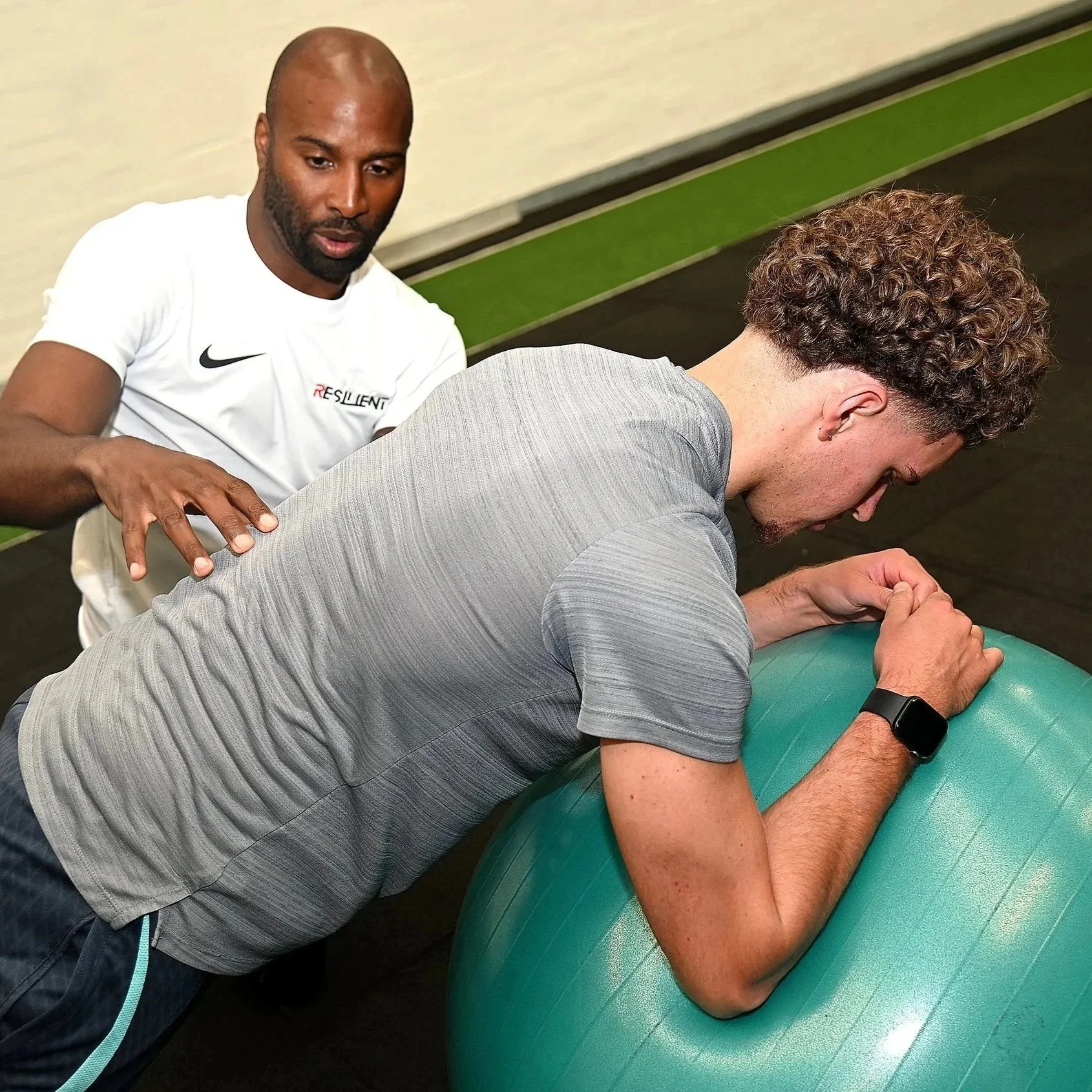 sports physiotherapy rehabilitation session with young adult footballer player