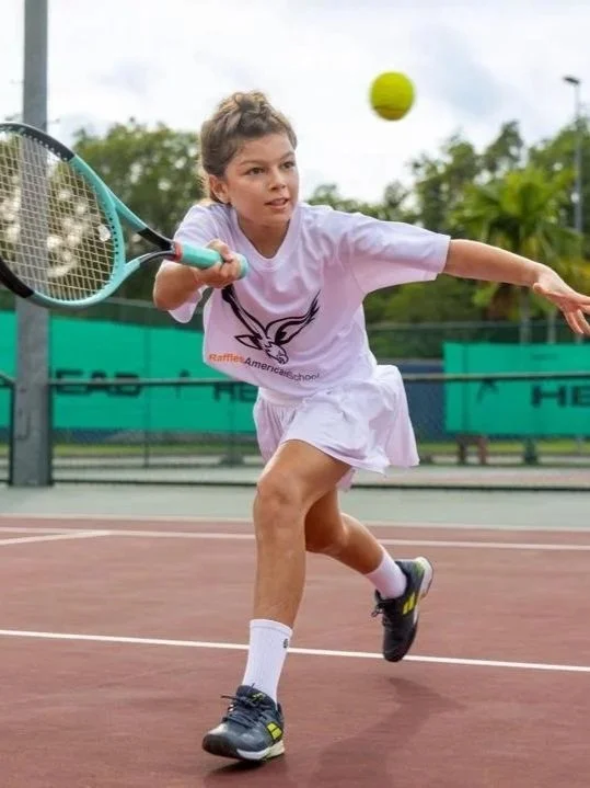 Highly rated young tennis player practising on court during a training session.