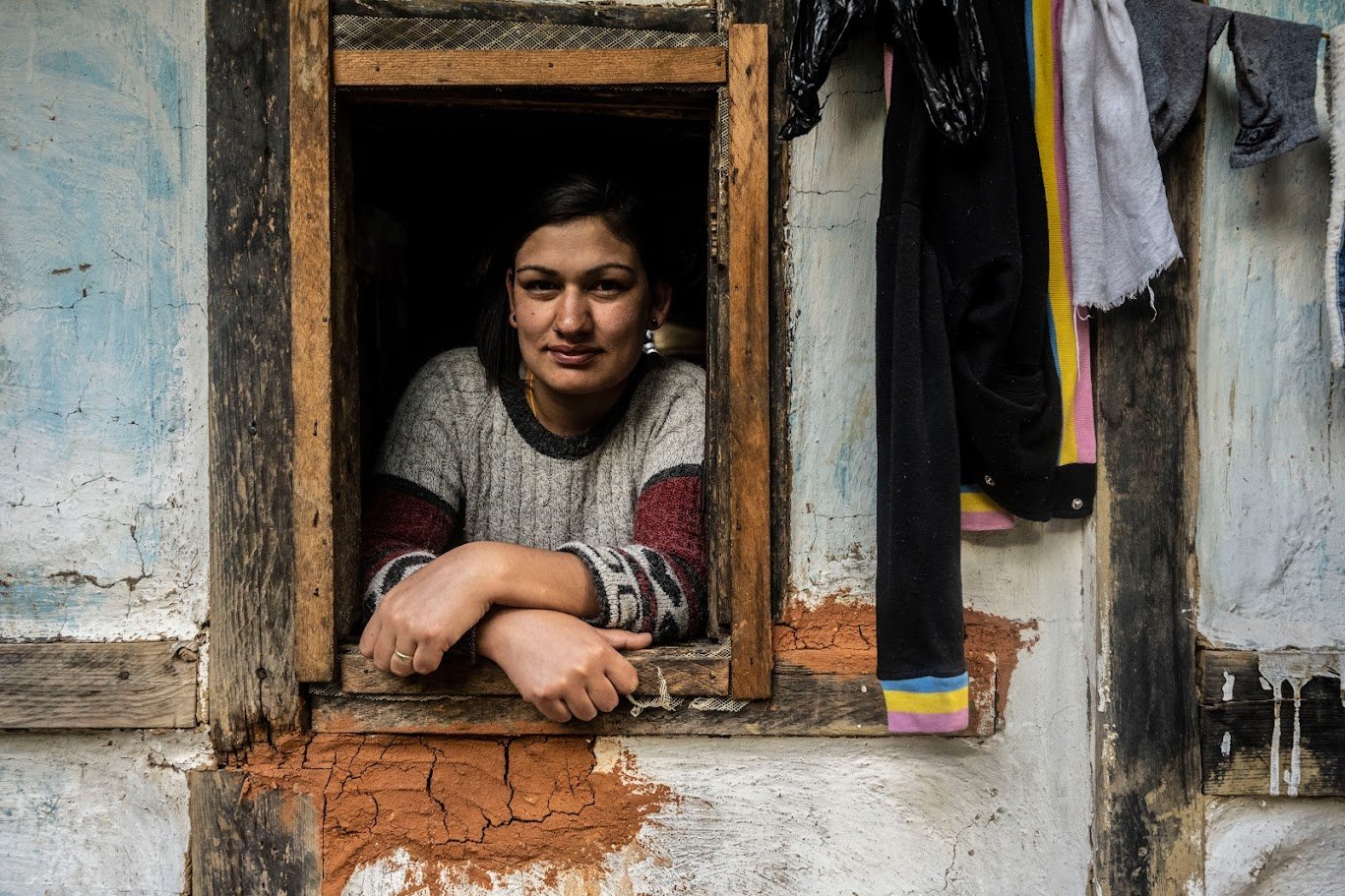 אישה נשענת על אדן חלון ישן, שקט סביב – בהוטן