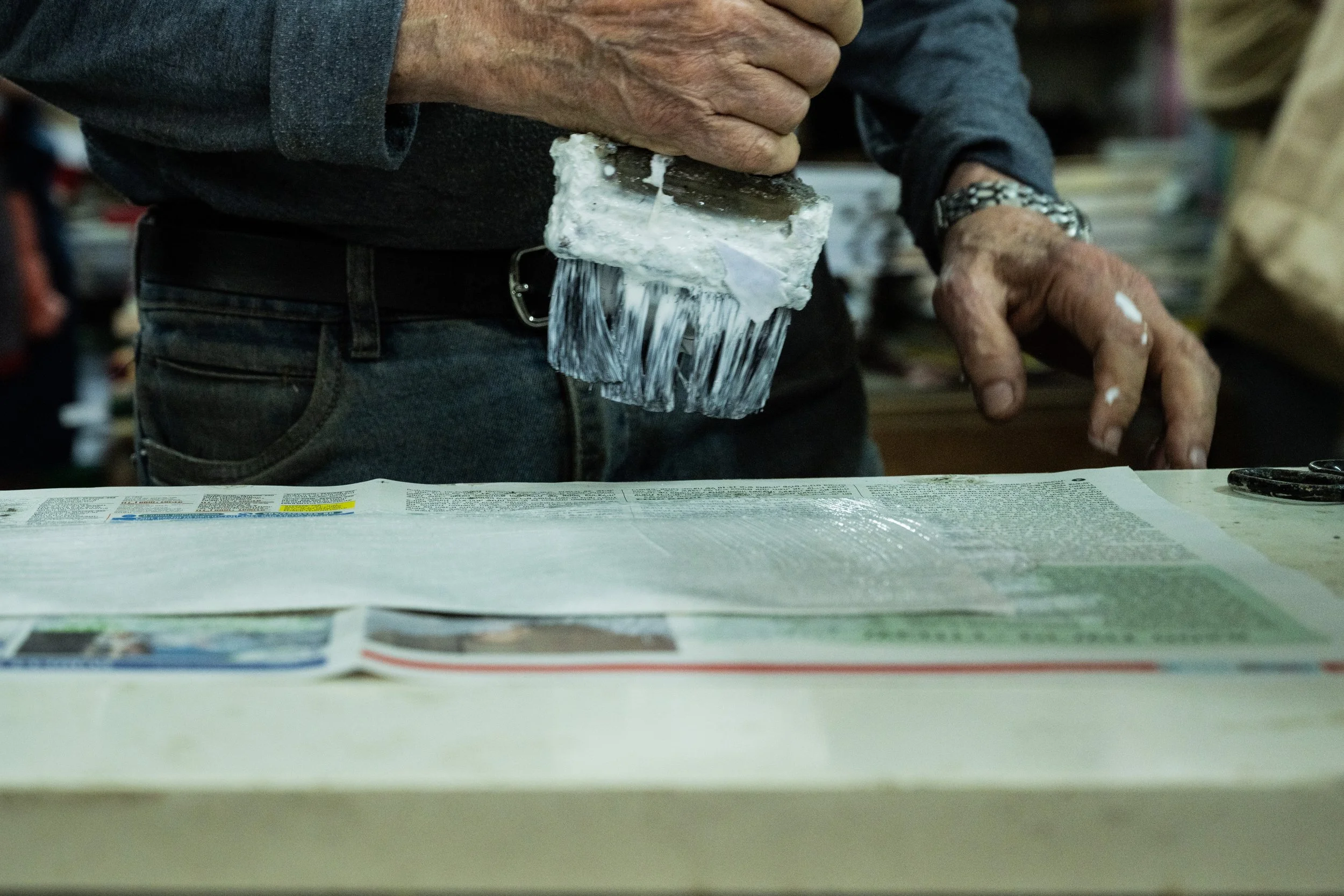 Close-up of the bookbinder’s hands