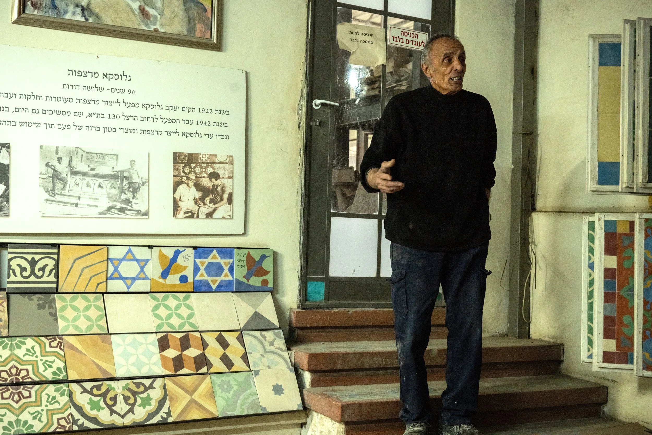 Avner Gluska standing on the steps of his workshop