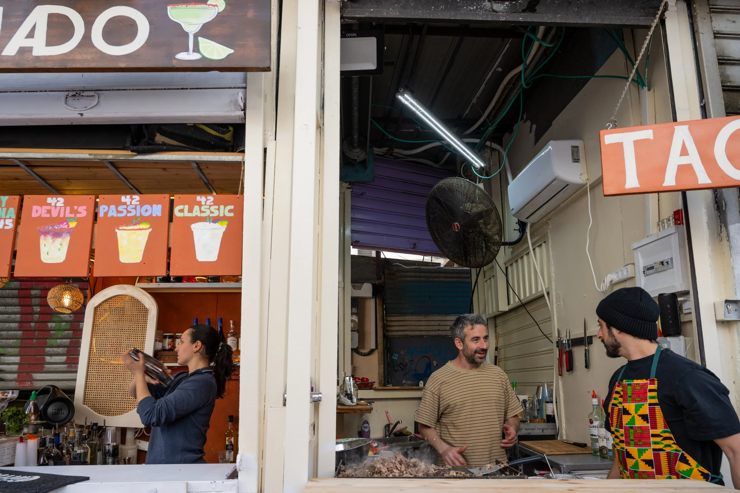 Vendors making meat and fruit shakes in Carmel Market