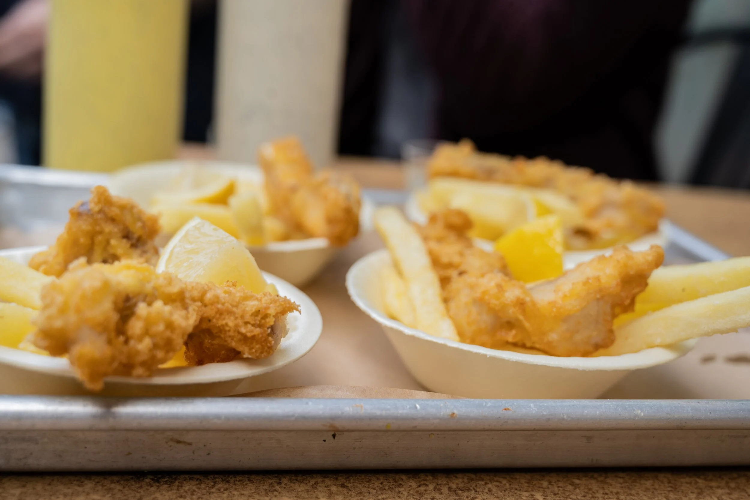 Fish and chips served hot with lemon at a market food stand