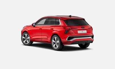 Red compact SUV viewed from the rear with black window trim and silver wheels