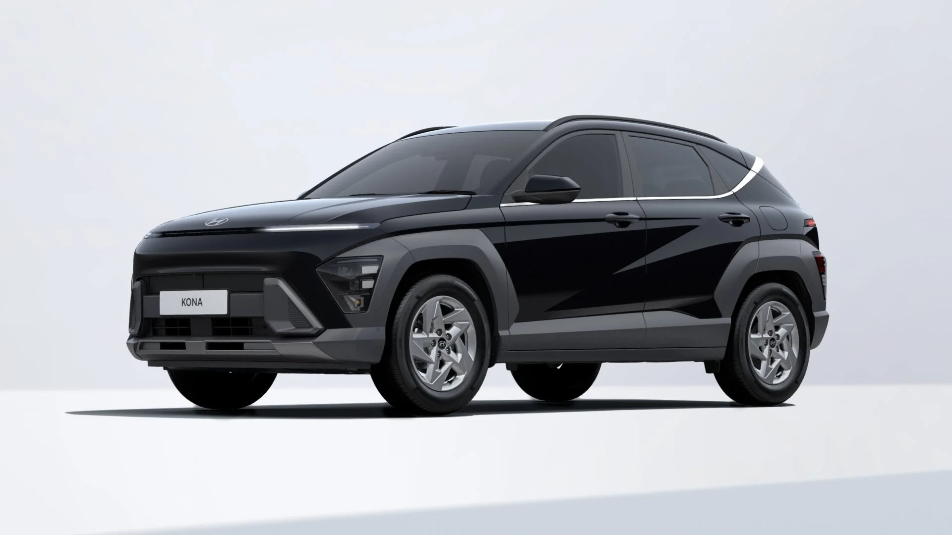 Black compact car with futuristic design, silver hubcaps, and a white license plate with the word 'KONA' on it, isolated on plain background.