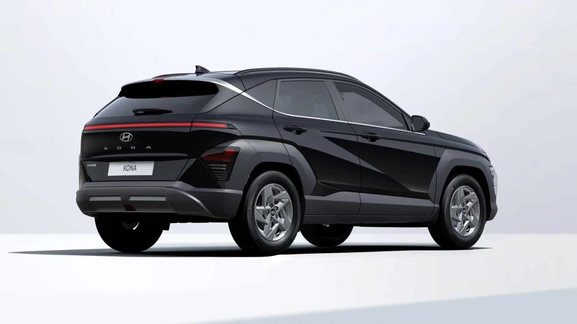 Black Hyundai Kona SUV shown in a studio setting, viewed from the rear right side.