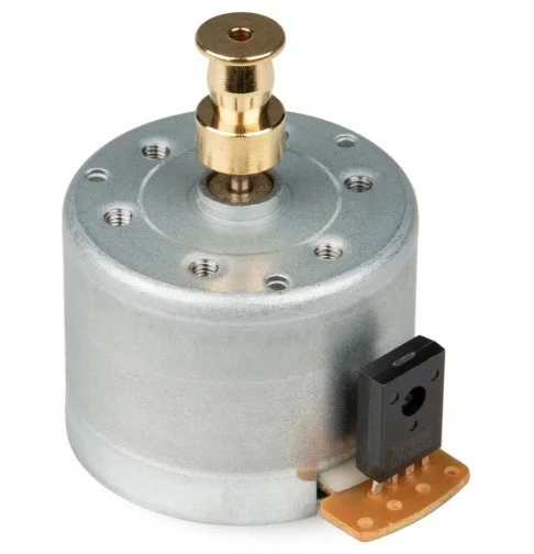 A small electric motor with a brass shaft and a black connector, used in electronic or robotic projects.