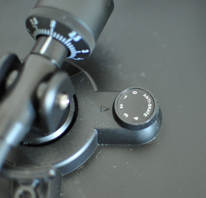 Close-up of a mechanical device with a dial labeled 'Antisulk' and a gauge with a needle pointing to 2.