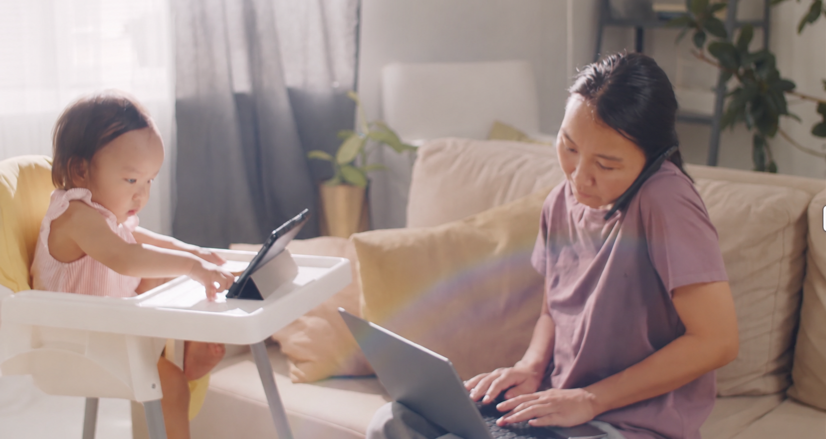 Child using iPad while adult is busy with screen time