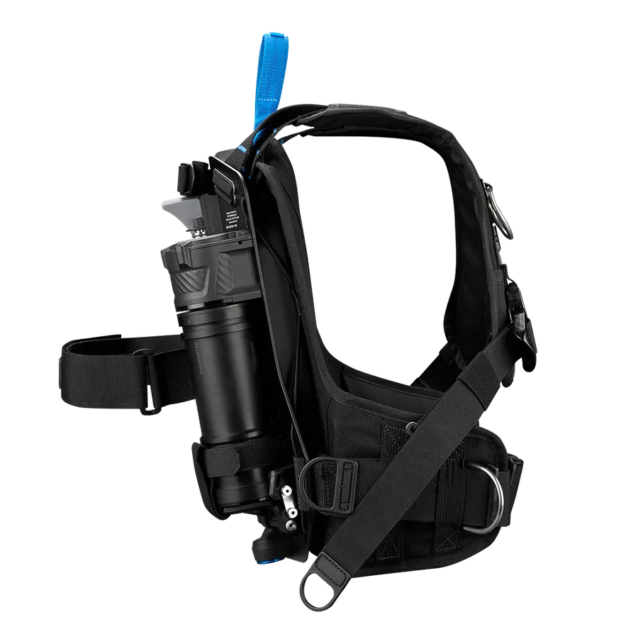 A black tactical harness with attached equipment, including a water bottle holder, a pouch, and straps for carrying gear.