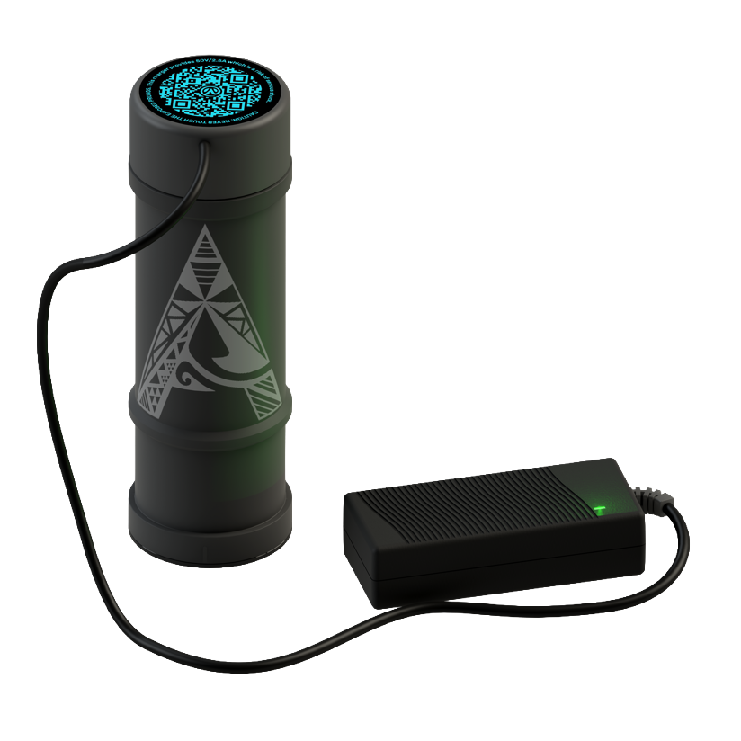 A cylindrical device with tribal-style patterns, connected via a cable to a rectangular electronic component with a green indicator light.
