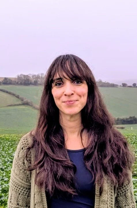 Michelle Saporta, founder of The Authentic Space Therapy, standing in a green field in Oxfordshire, representing a calm and grounded therapeutic approach.