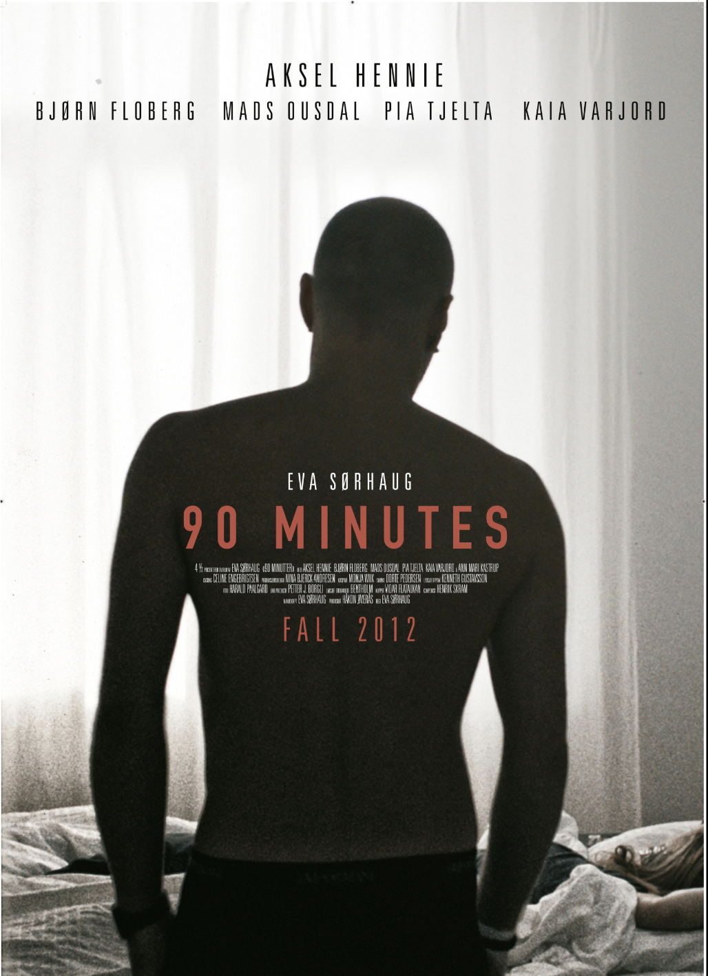 Silhouette of a shirtless man standing in front of a light-colored curtain in a bedroom, with text overlay about the film '90 Minutes' by Eva Sørhaugg, released in Fall 2012.