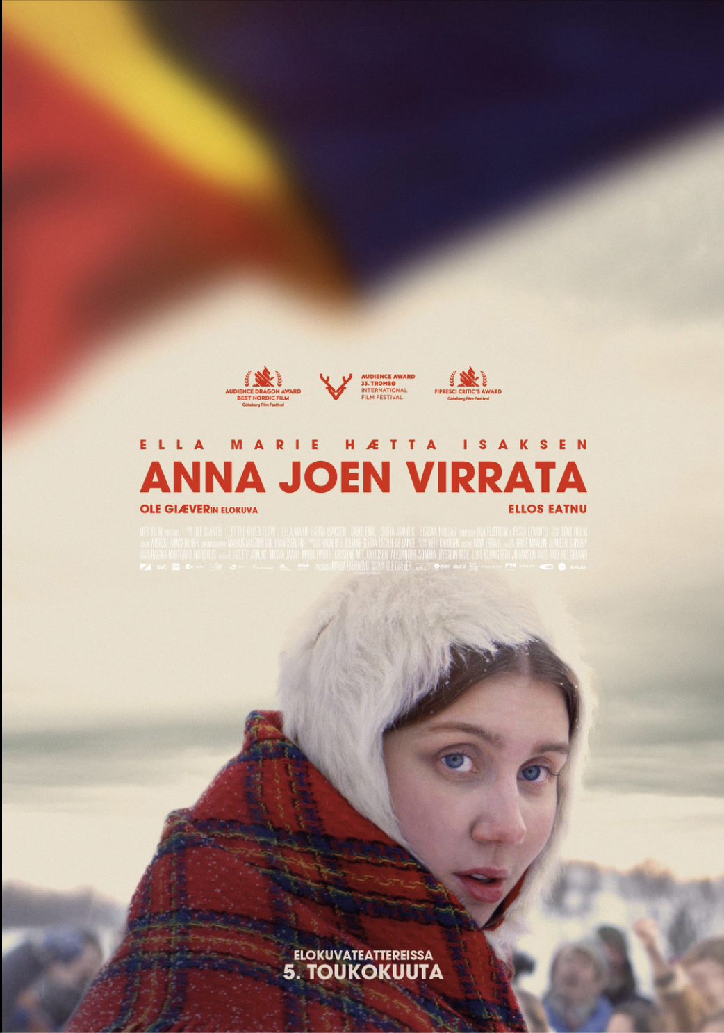 A movie poster for 'Anna Jone Virrata' featuring a young girl with blue eyes wearing a white furry hat and a red plaid coat, with a cloudy sky in the background and several blurred people behind her.
