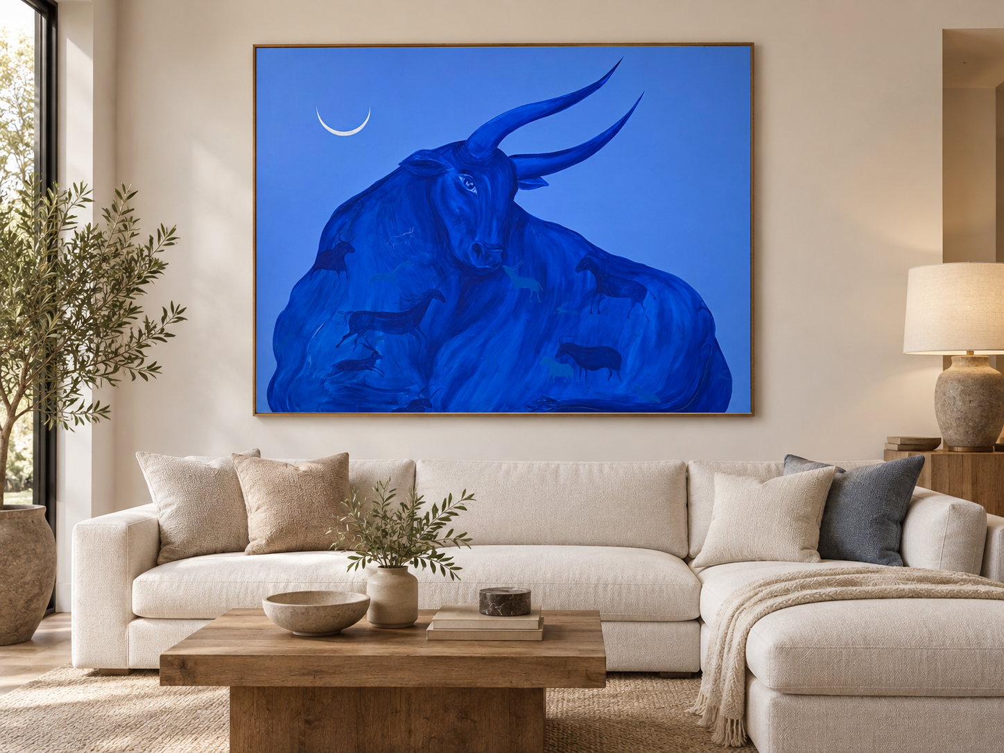 Mother of Pearl by Jevgenia Vassiljeva, a 190 × 150 cm blue acrylic painting featuring a monumental bull, crescent moon and hidden animal figures, shown in a contemporary interior.