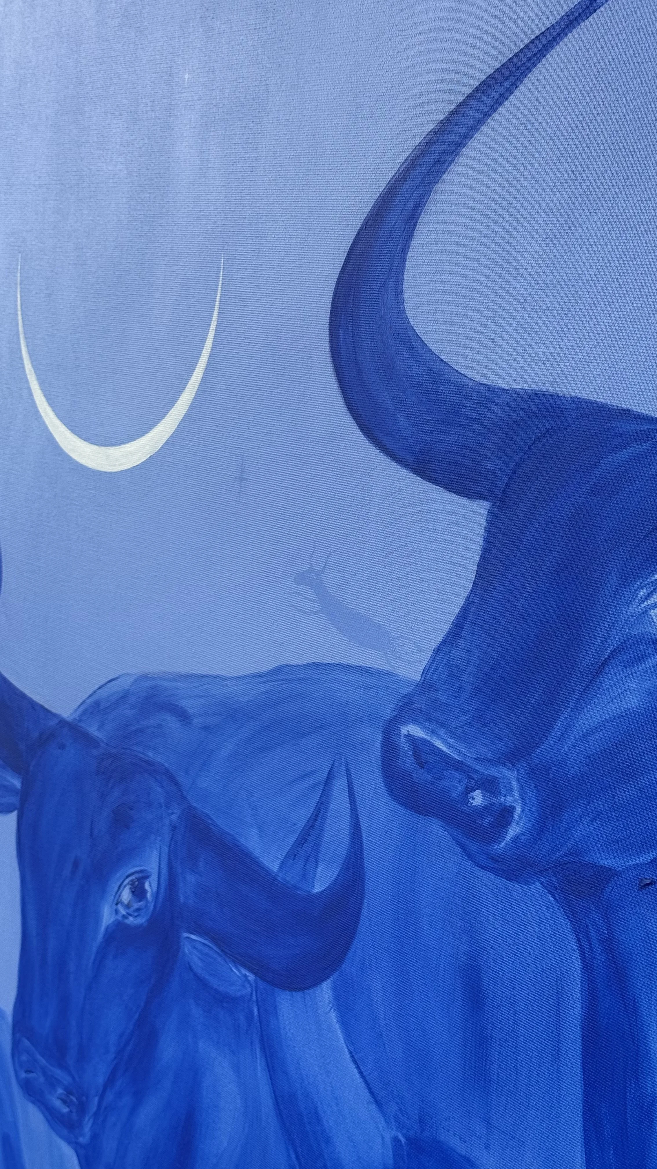 Large contemporary blue painting We Were Here Before by Jevgenia Vassiljeva, depicting a layered herd of cobalt blue bulls beneath a white crescent moon on a light blue background.