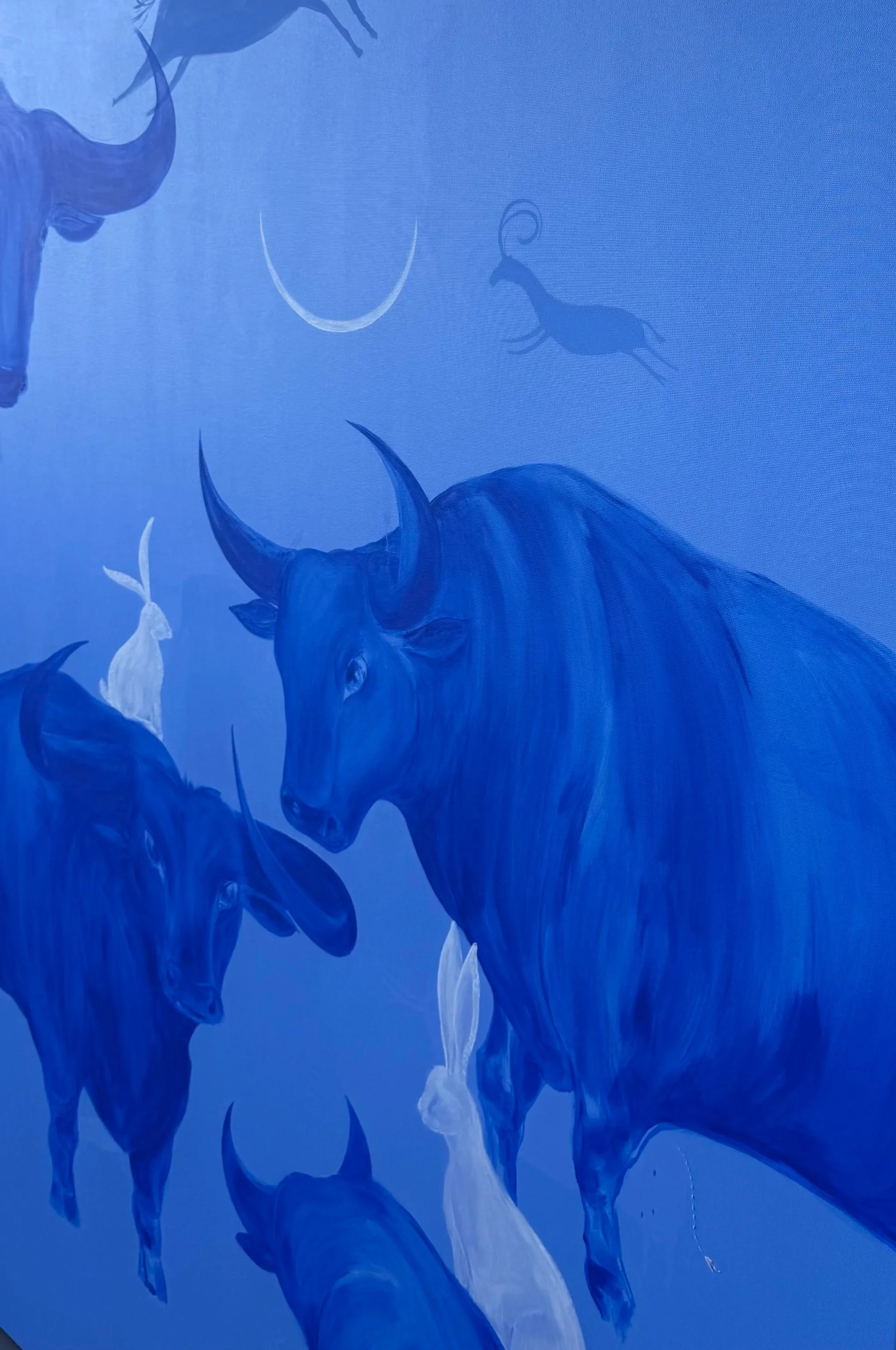 Detail of Nothing Was Lost, blue acrylic painting with layered bulls and white hares by Jevgenia Vassiljeva