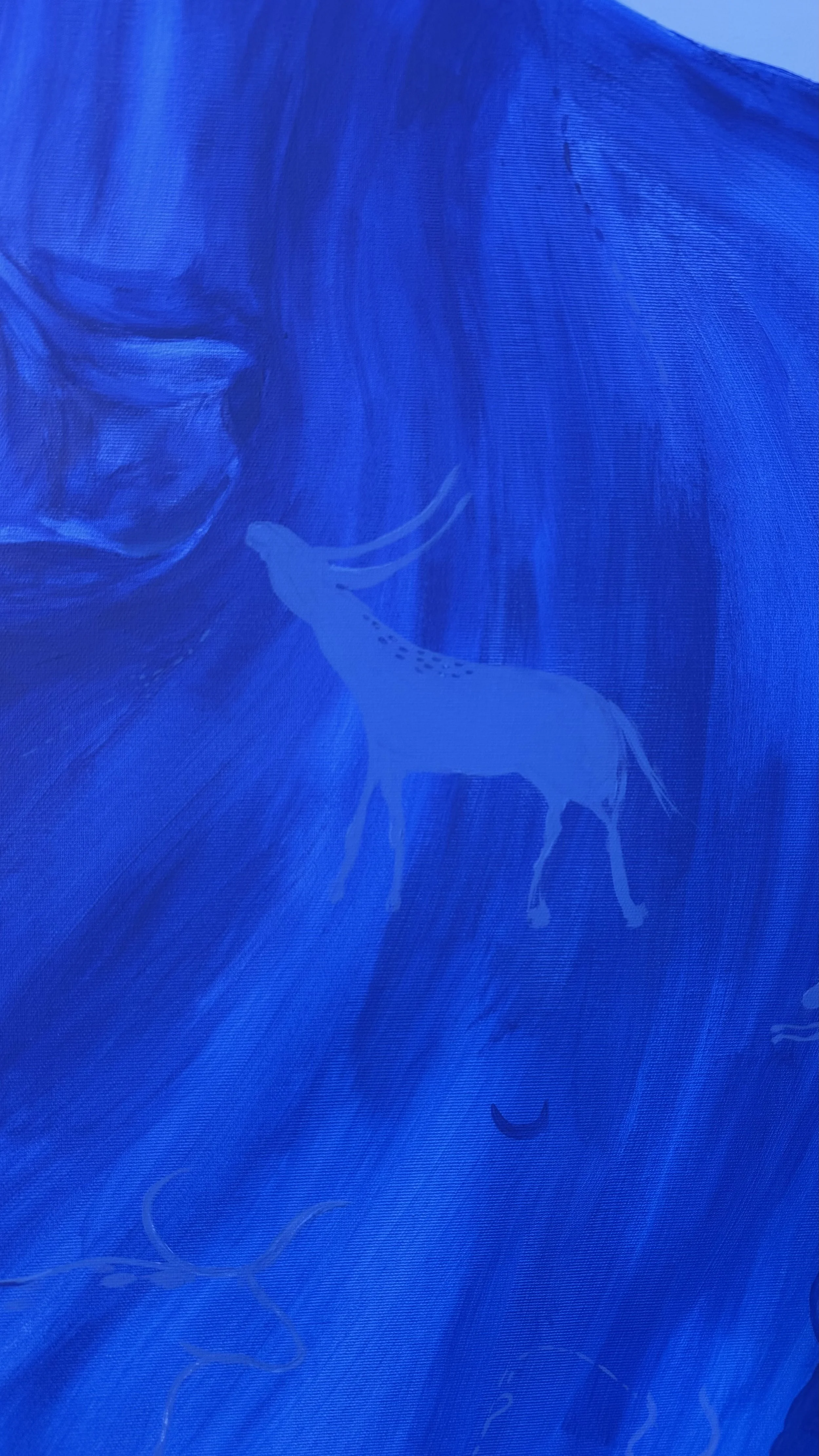 Mother of Pearl by Jevgenia Vassiljeva, a 190 × 150 cm blue acrylic painting featuring a monumental bull, crescent moon and hidden animal figures, shown in a contemporary interior.